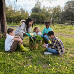 A woman and children surrounding harvested vegetables